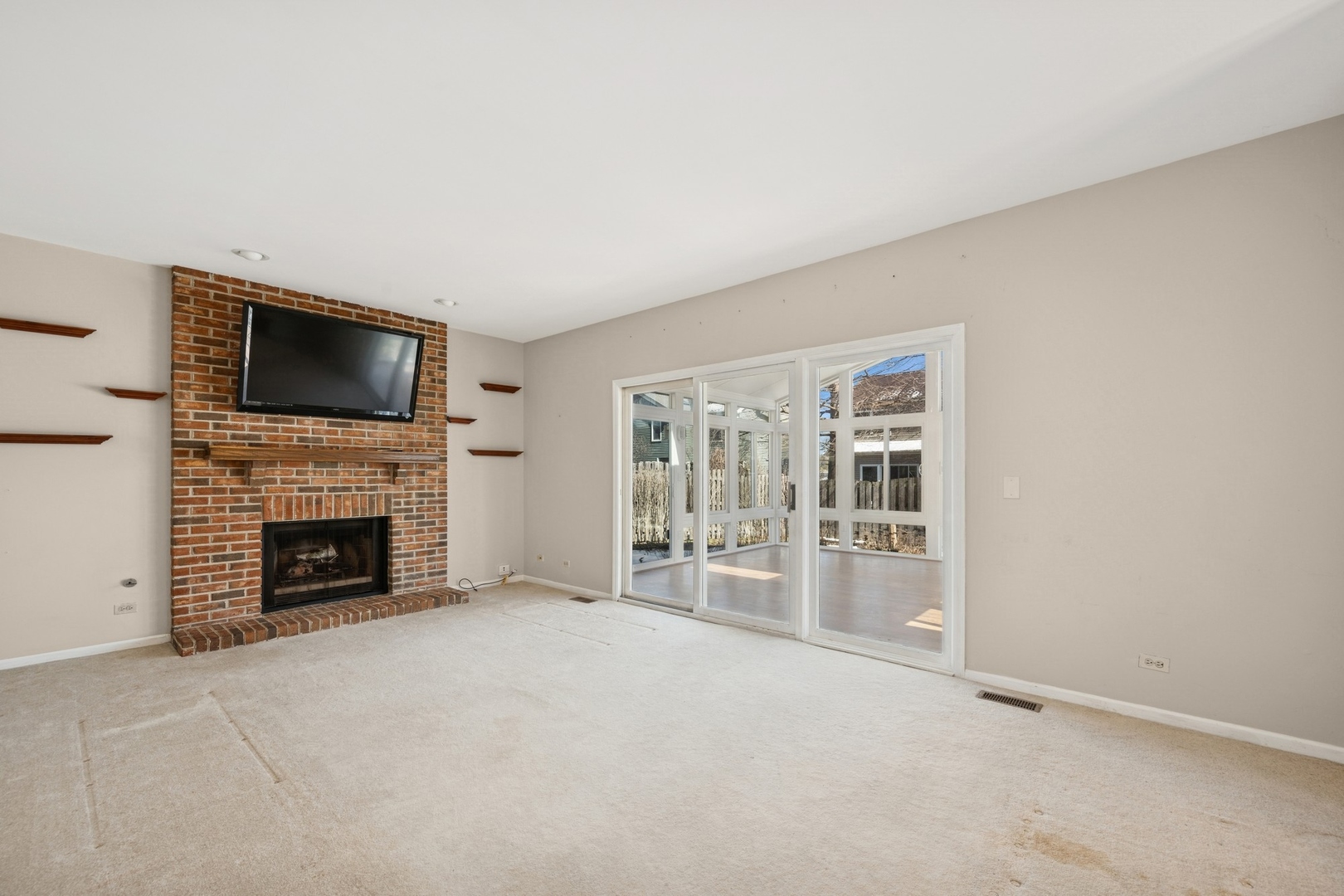 1005 Honeysuckle Drive Wheeling, IL 60090 - Photo 9 of 25 an empty room with furniture and a fireplace