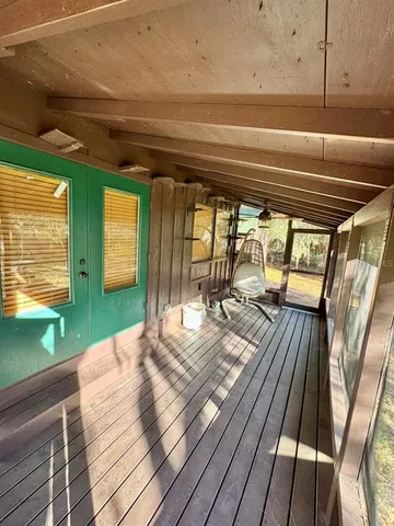 a view of a balcony with wooden floor