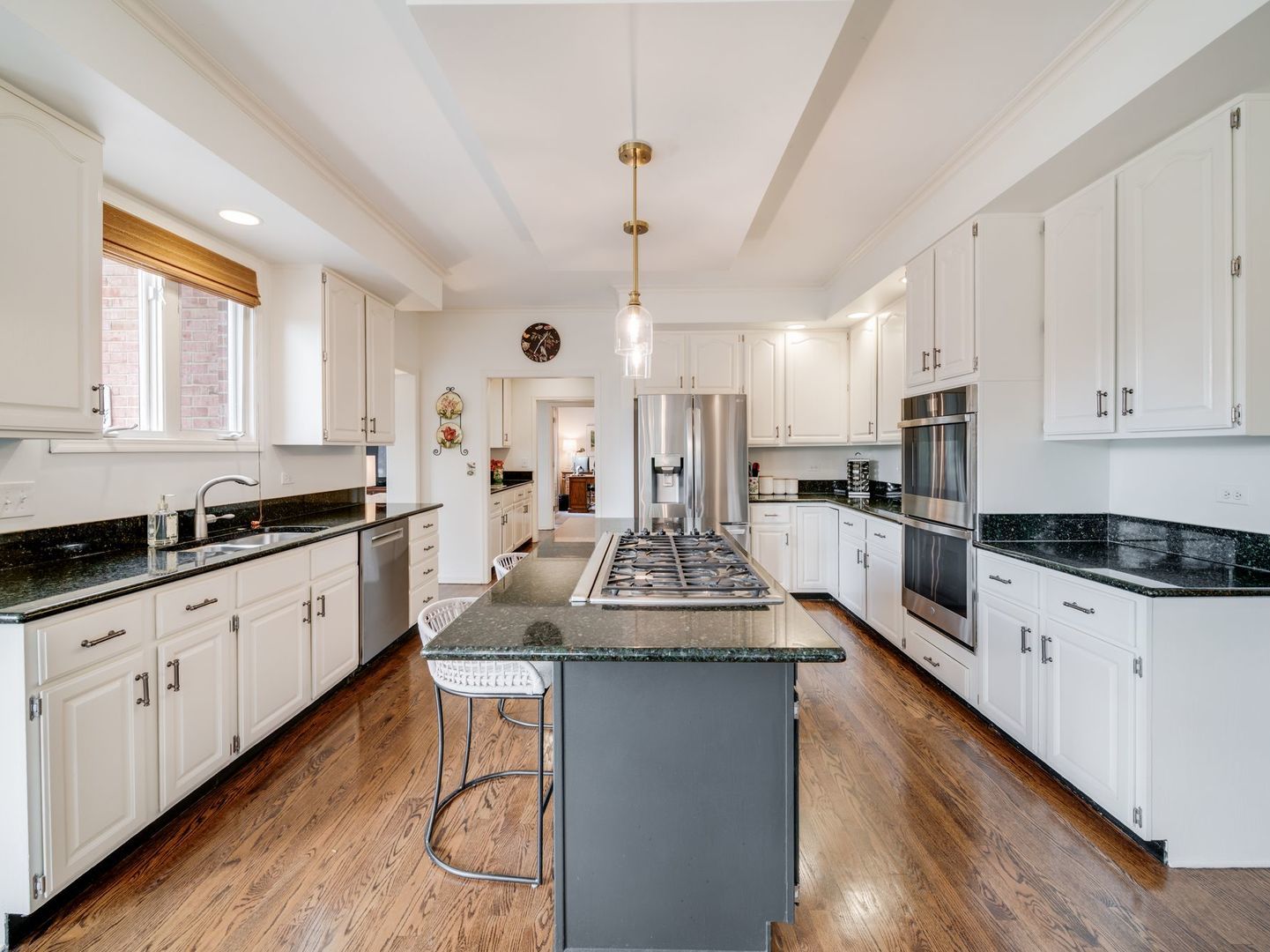 626 Buena Road Lake Forest, IL 60045 - Photo 12 of 37 a large kitchen with stainless steel appliances granite countertop a stove a sink dishwasher and a refrigerator with wooden floor