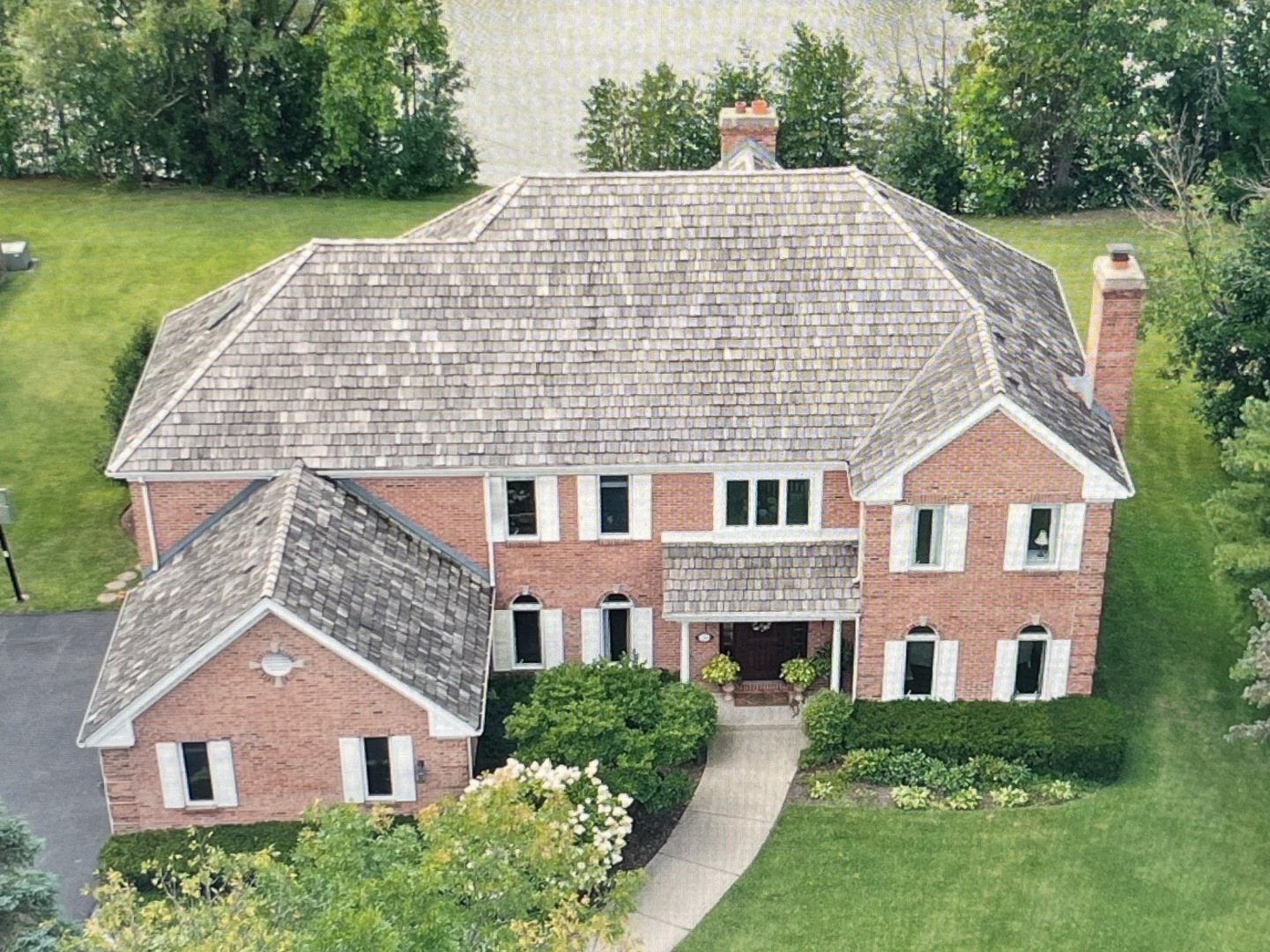 626 Buena Road Lake Forest, IL 60045 - Photo 37 of 37 a aerial view of a brick house next to a yard with big trees