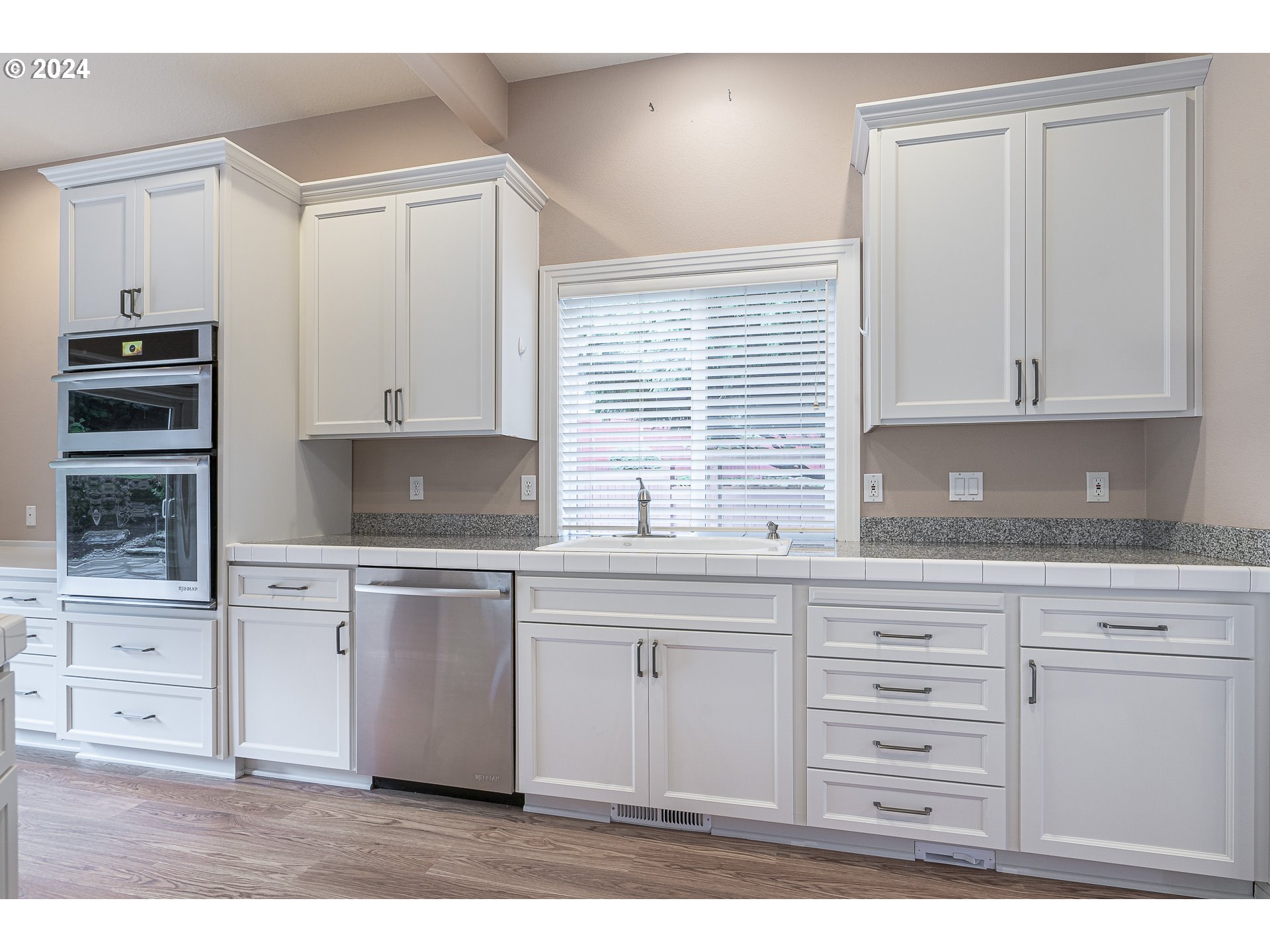 11084 Southeast Valley Way Happy Valley, OR 97086 - Photo 12 of 40 a kitchen with granite countertop white cabinets and stainless steel appliances