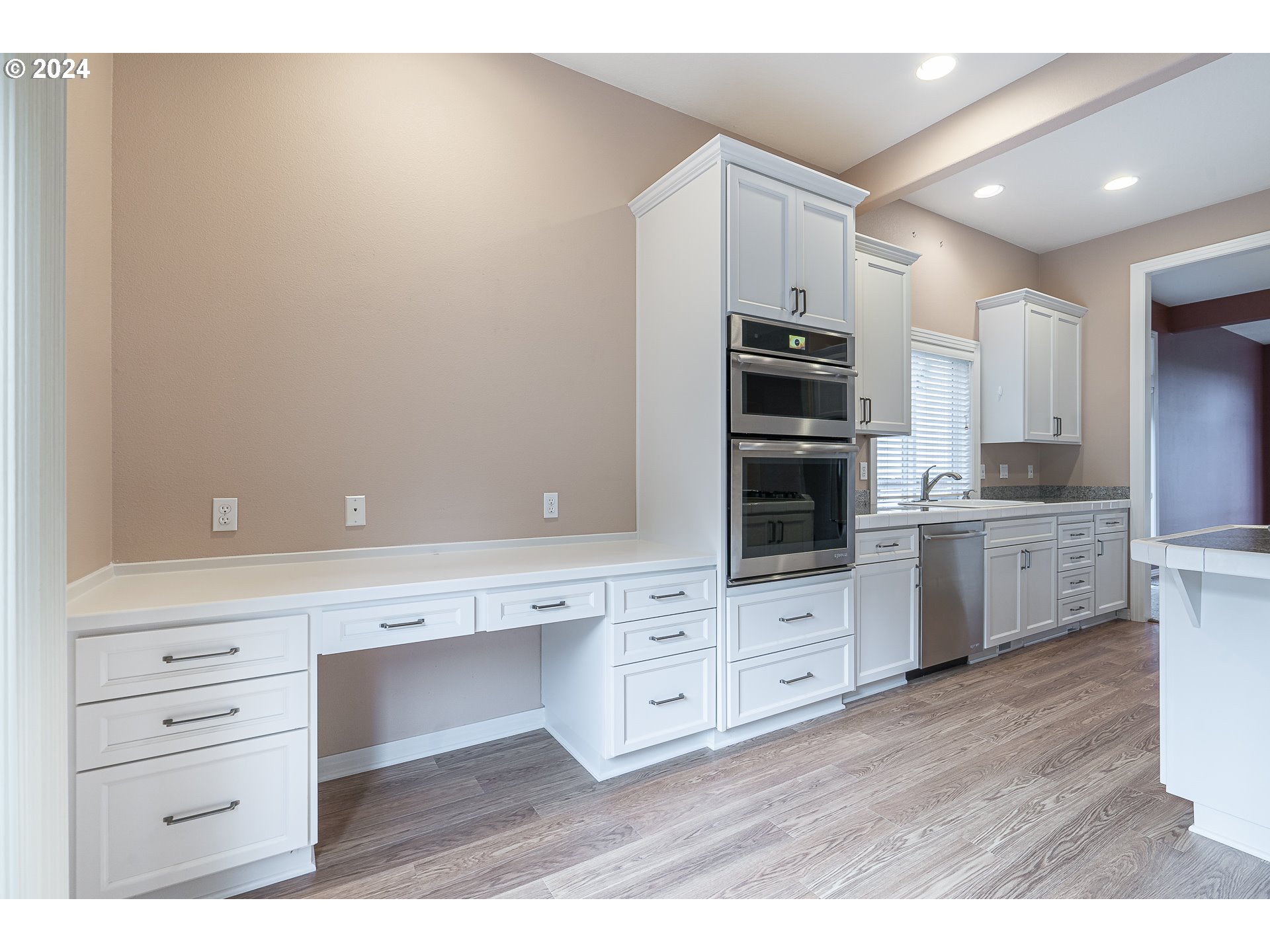 11084 Southeast Valley Way Happy Valley, OR 97086 - Photo 13 of 40 a kitchen with white cabinets and stainless steel appliances