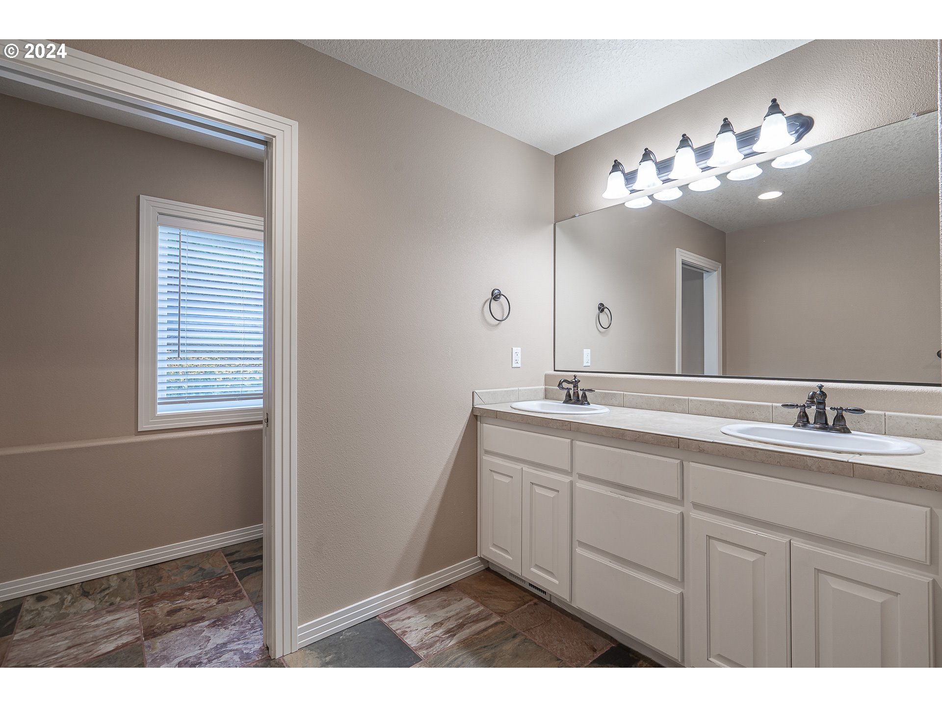 11084 Southeast Valley Way Happy Valley, OR 97086 - Photo 23 of 40 a bathroom with a sink and a mirror