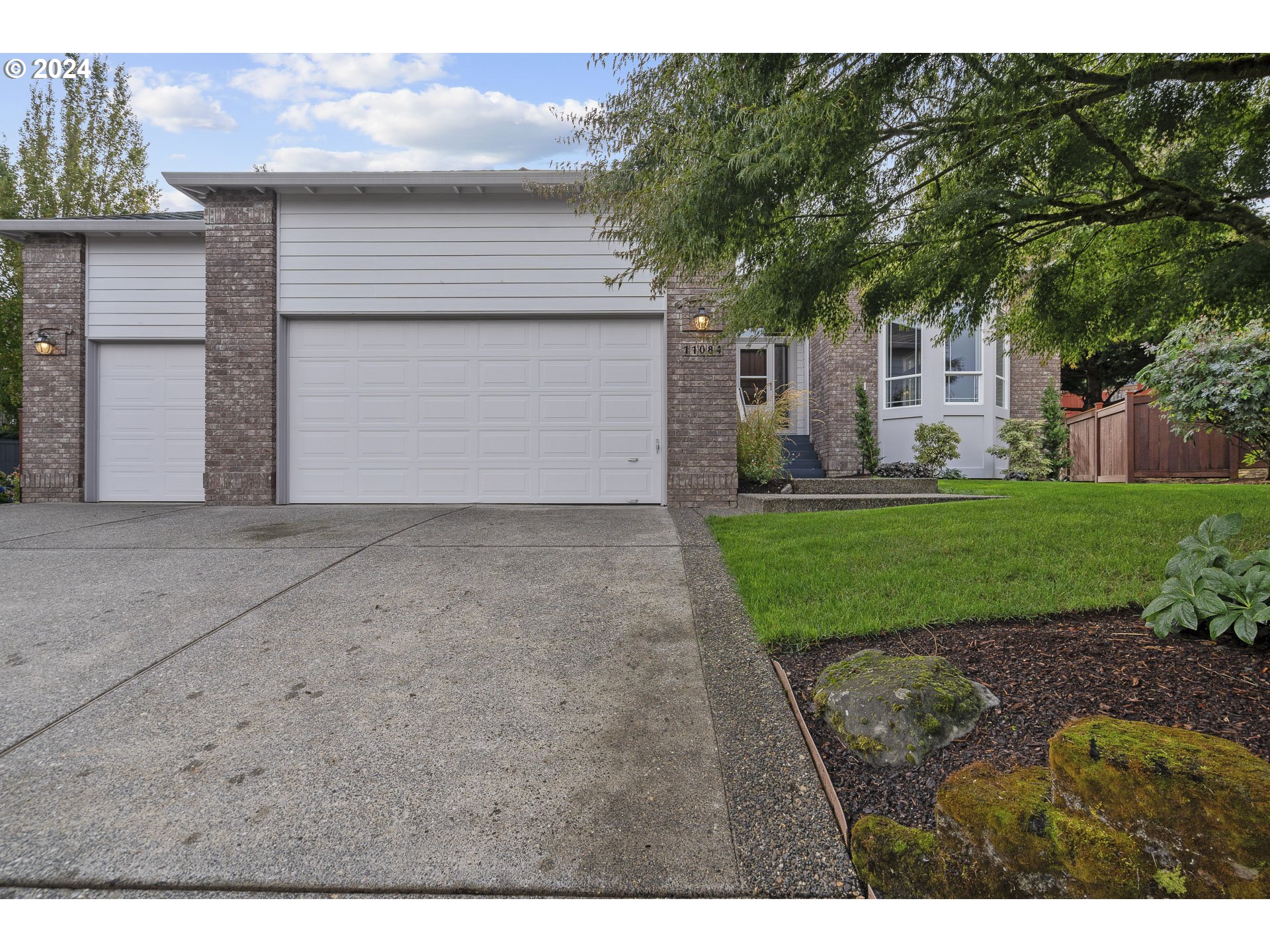 11084 Southeast Valley Way Happy Valley, OR 97086 - Photo 3 of 40 a front view of a house with a yard and garage