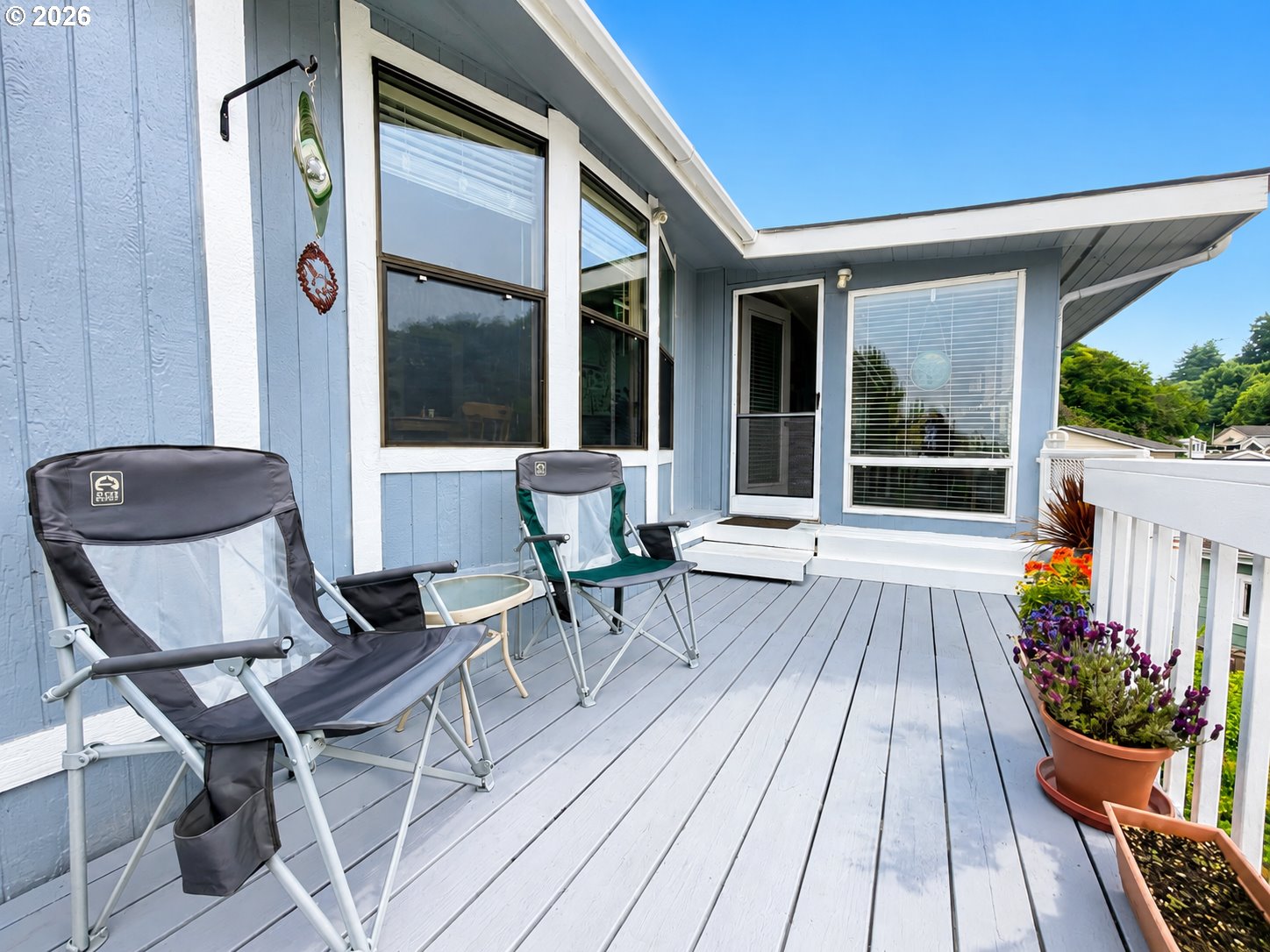16219 Lower Harbor Road, Unit 16 Brookings, OR 97415 - Photo 27 of 40 a balcony with wooden floor and outdoor seating
