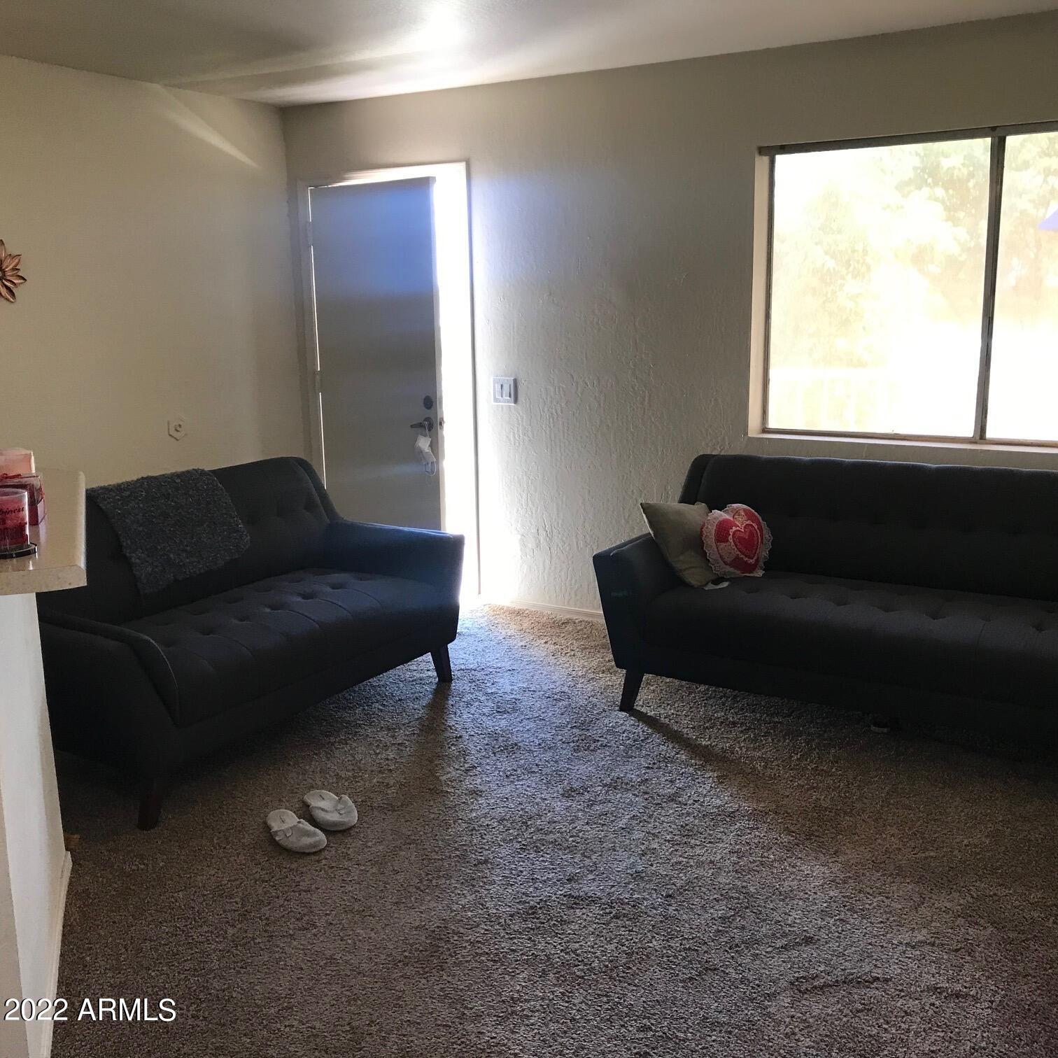 12221 West Bell Road, Unit 370 Surprise, AZ 85378 - Photo 2 of 18 a living room with furniture and a window