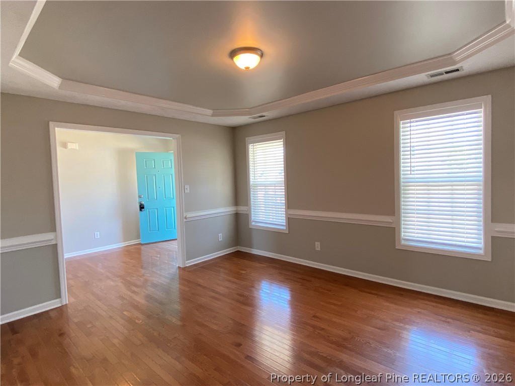 58 Polk Street Spring Lake, NC 28390 - Photo 5 of 26 an empty room with wooden floor and windows