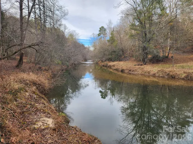 a view of a yard with wooden fence