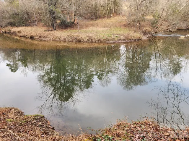 a view of backyard with wooden fence