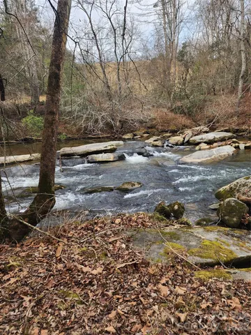 a view of a yard with wooden fence