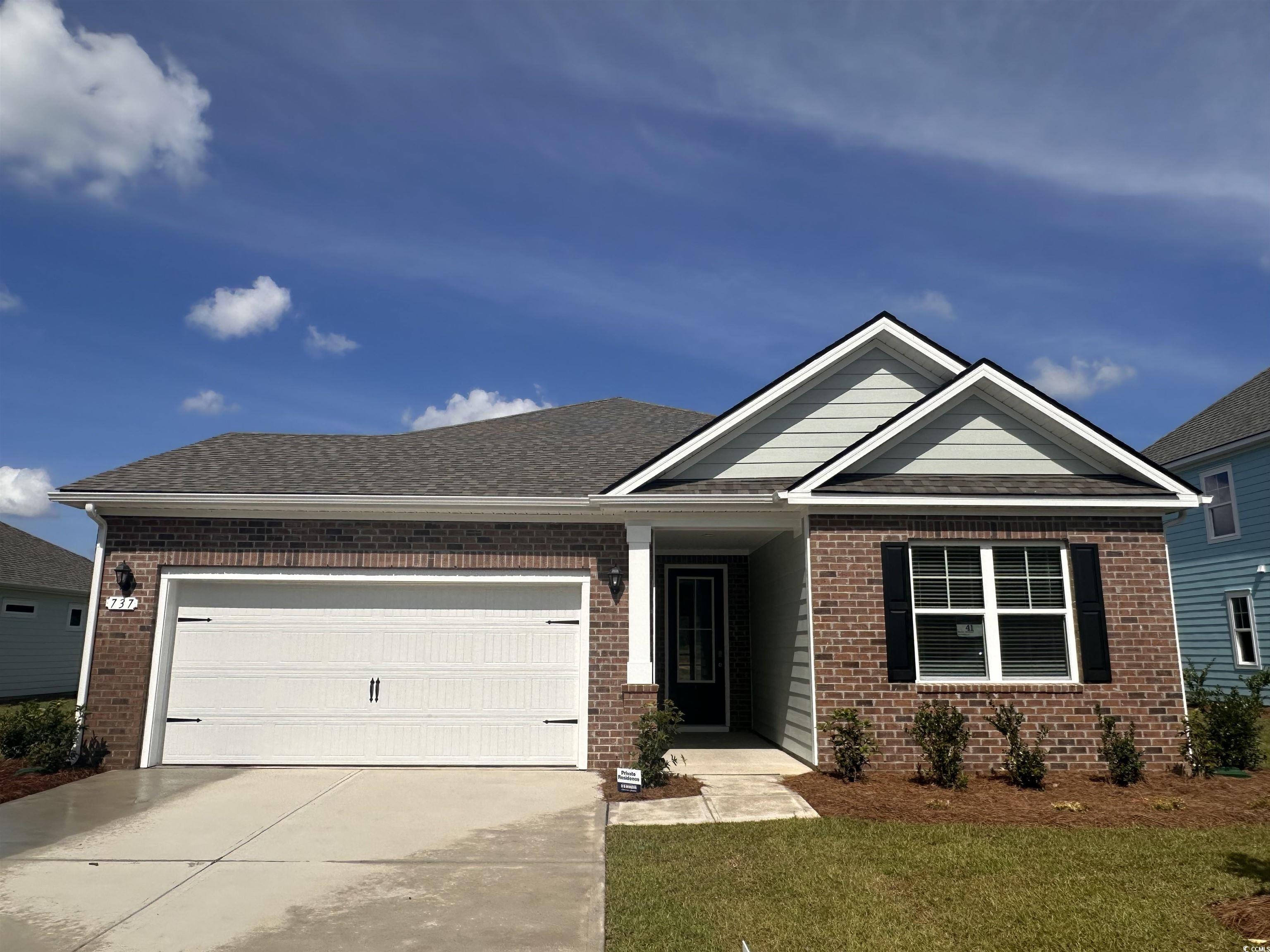 737 Doonbeg Court Conway, SC 29526 - Photo 1 of 33 View of front of home featuring brick siding, a shingled roof, an attached garage, concrete driveway, and a front yard