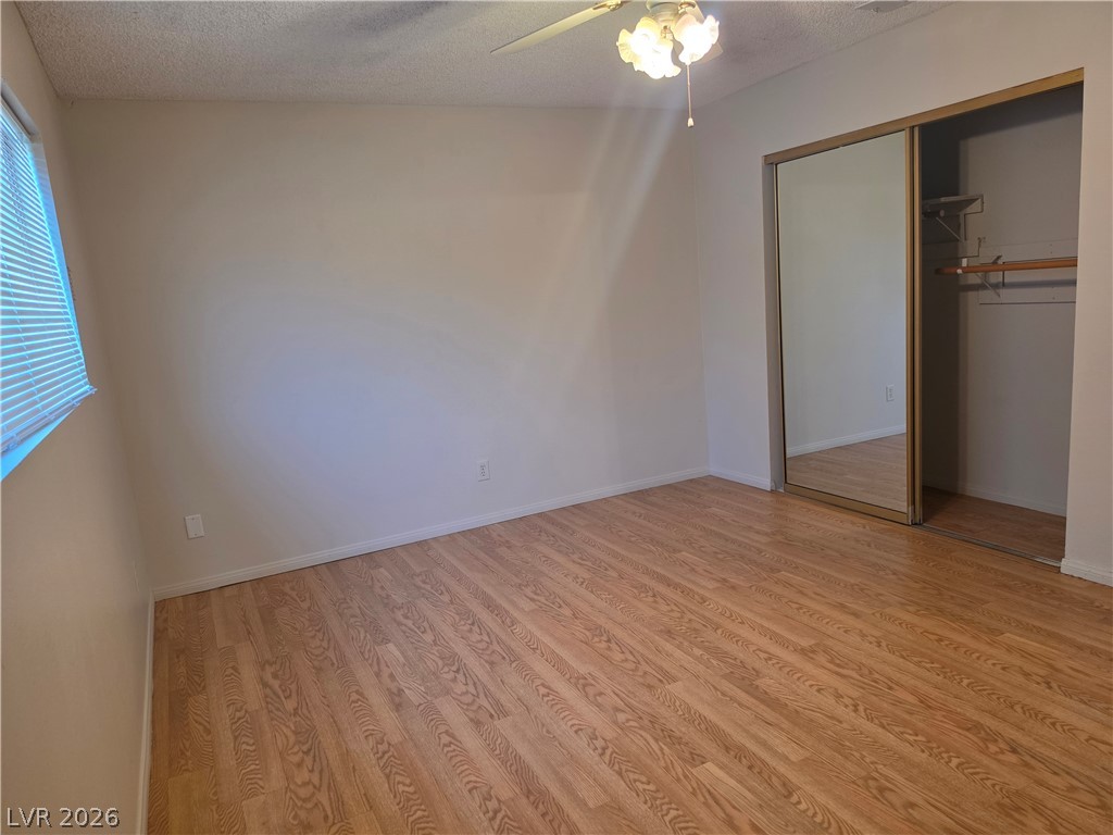 5289 Reeder Circle Las Vegas, NV 89119 - Photo 26 of 40 Warm wood flooring and a mirrored closet define this comfortable bedroom space.