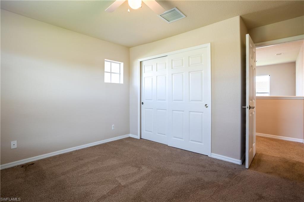9026 Astonia Way Estero, FL 33967 - Photo 25 of 38 an empty room with windows and closet