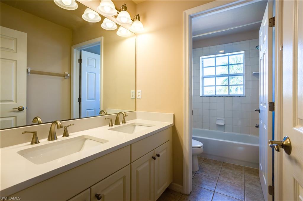 9026 Astonia Way Estero, FL 33967 - Photo 26 of 38 a bathroom with a sink a vanity and a mirror