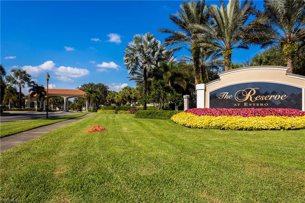 9026 Astonia Way Estero, FL 33967 - Photo 3 of 38 a view of building with sign board and yard