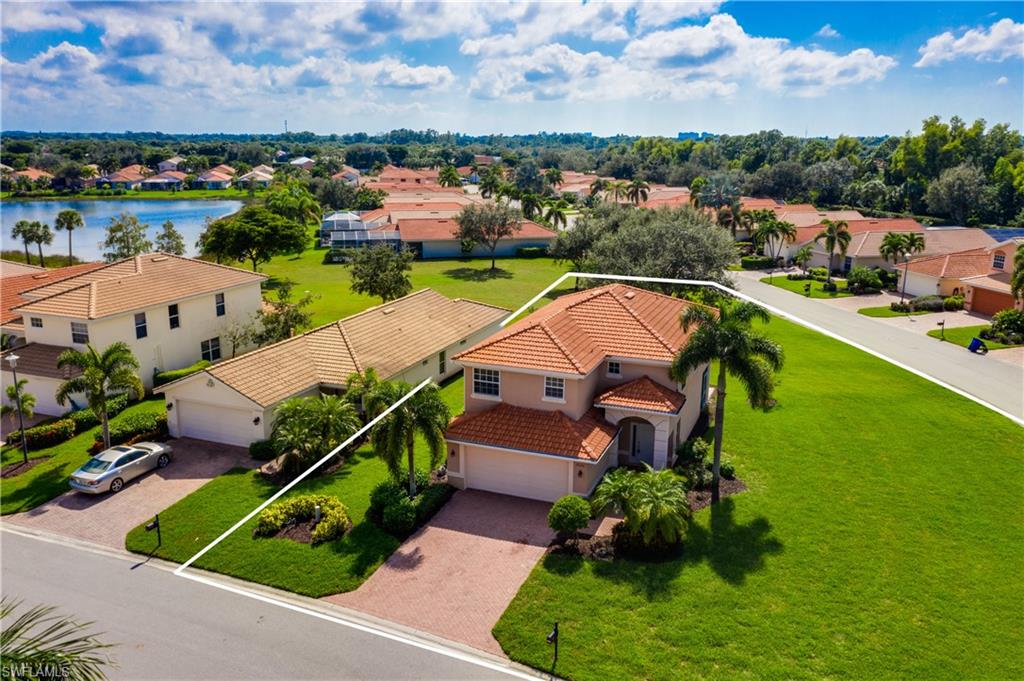 9026 Astonia Way Estero, FL 33967 - Photo 34 of 38 an aerial view of a house with a garden and lake view