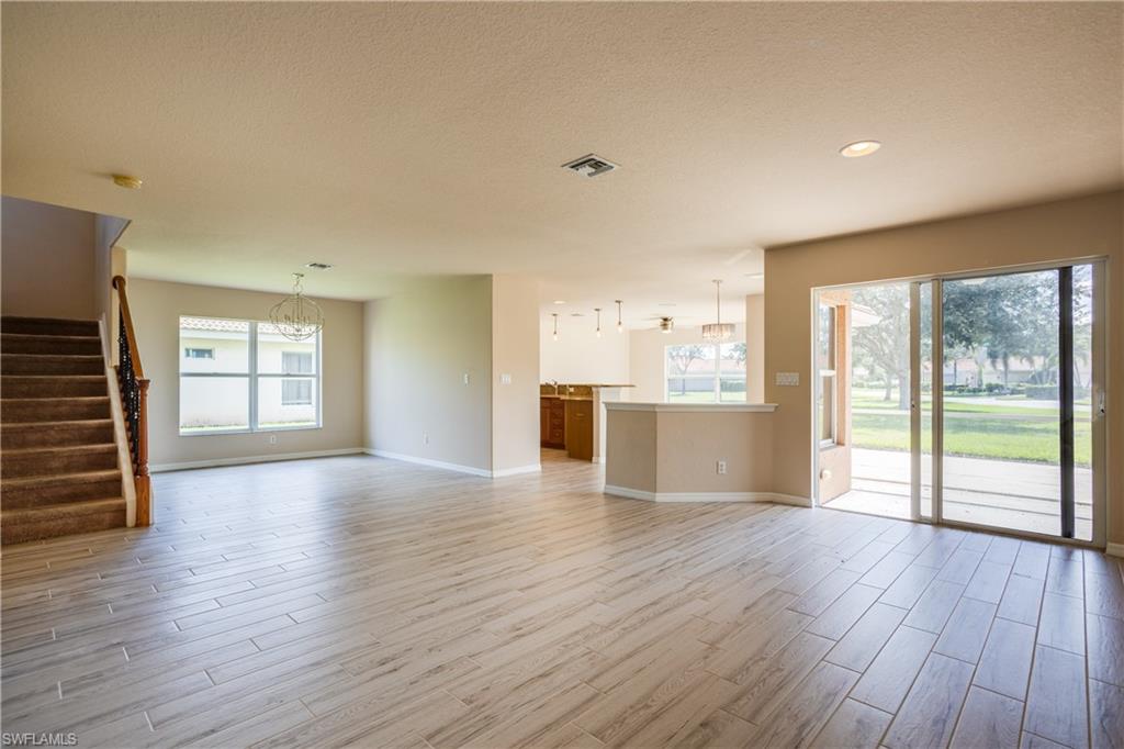 9026 Astonia Way Estero, FL 33967 - Photo 4 of 38 a view of an empty room with wooden floor and a window