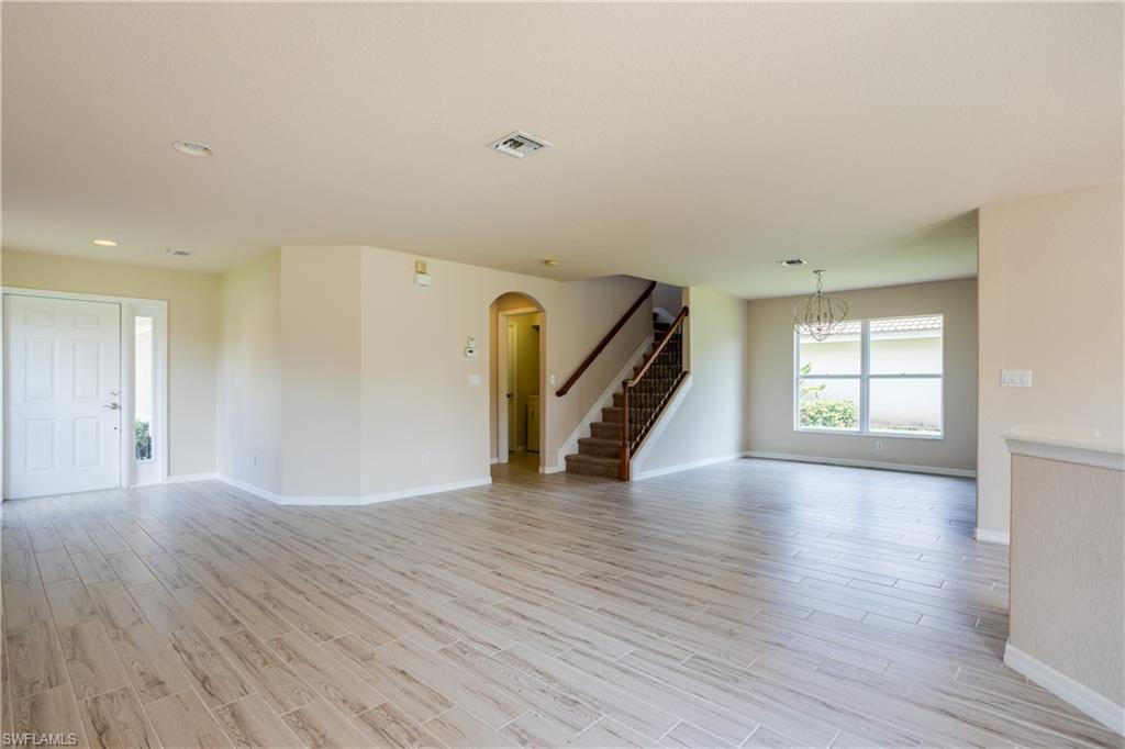 9026 Astonia Way Estero, FL 33967 - Photo 5 of 38 a view of empty room with wooden floor and window