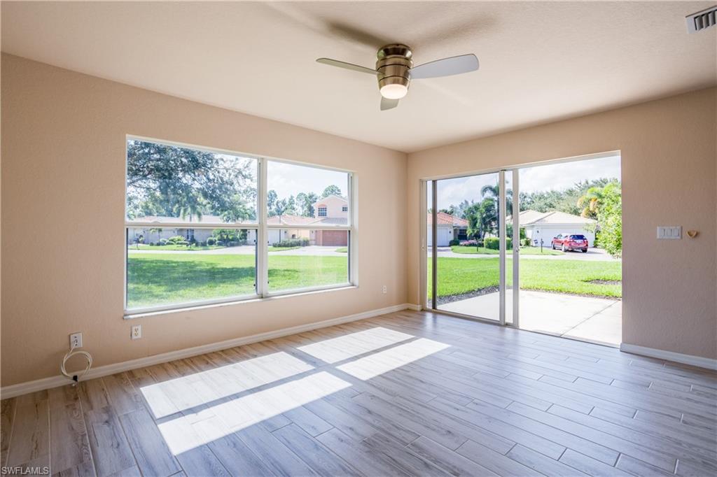 9026 Astonia Way Estero, FL 33967 - Photo 8 of 38 a open hall with wooden floor fan and windows