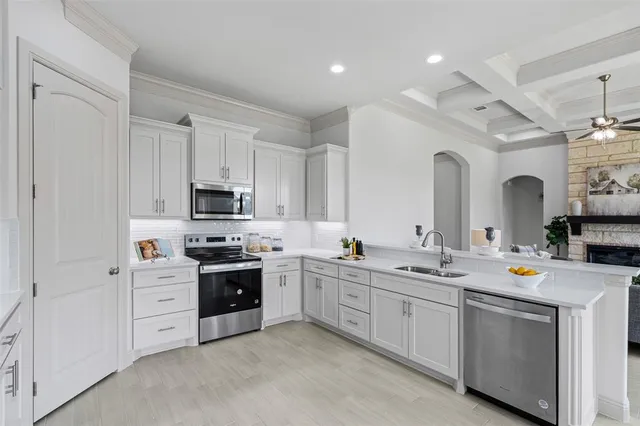a kitchen with white cabinets and white appliances