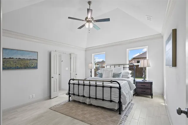 a bedroom with a bed and a chandelier