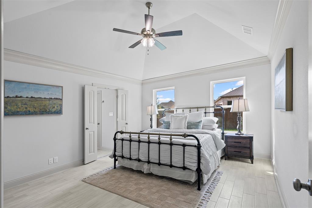 725 Jameson Springtown, TX 76082 - Photo 15 of 38 a bedroom with a bed and a chandelier