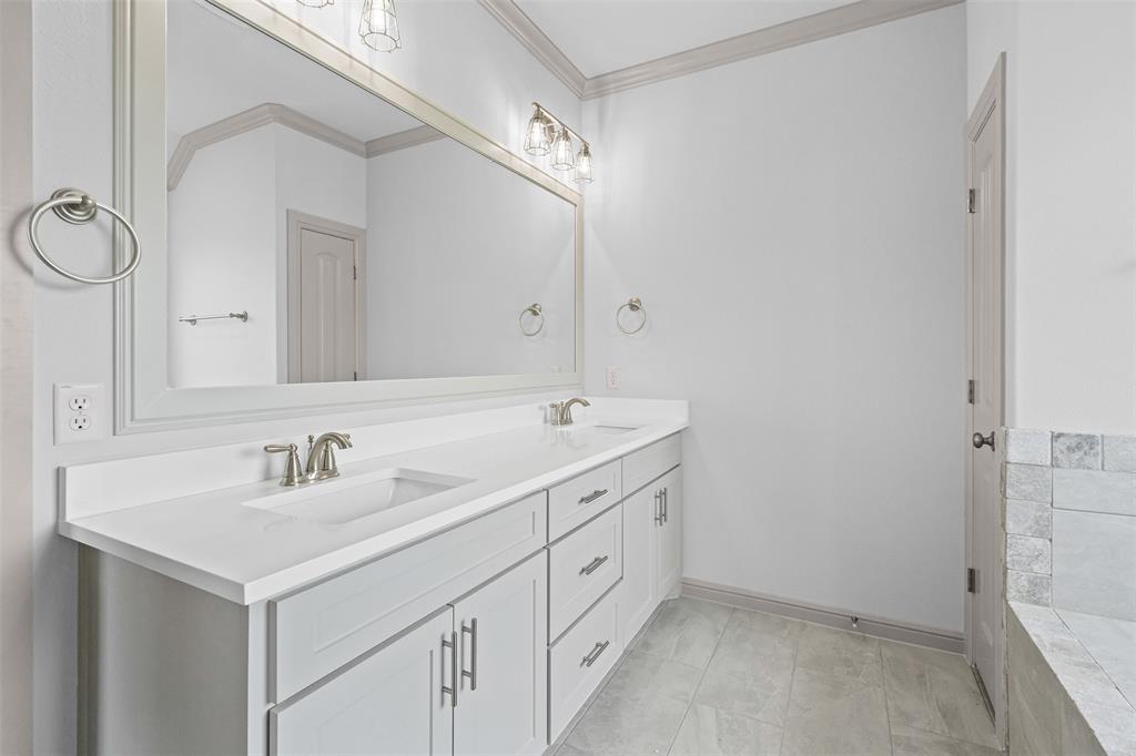 725 Jameson Springtown, TX 76082 - Photo 21 of 38 a bathroom with 2 sink and a mirror