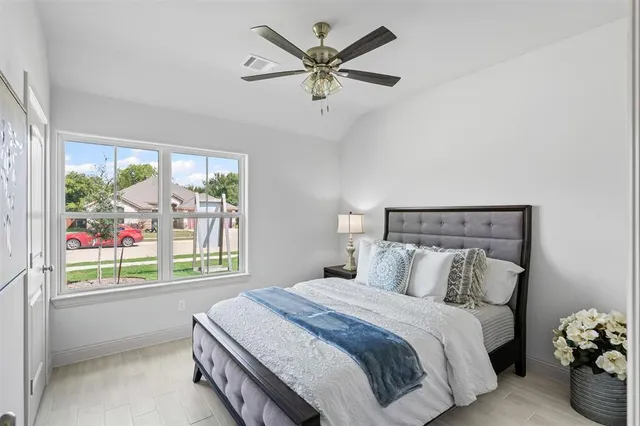 a bedroom with a bed and a large window