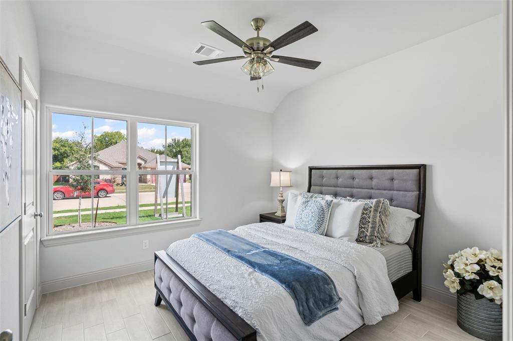 725 Jameson Springtown, TX 76082 - Photo 23 of 38 a bedroom with a bed and a large window