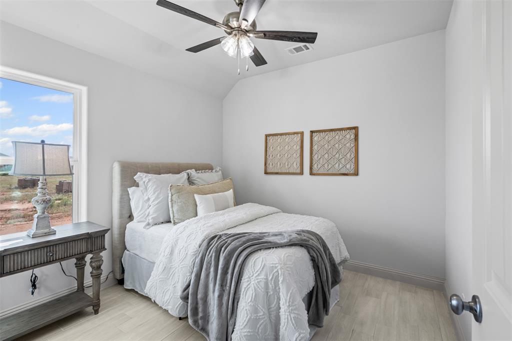 725 Jameson Springtown, TX 76082 - Photo 24 of 38 a bedroom with a bed and a painting on the wall