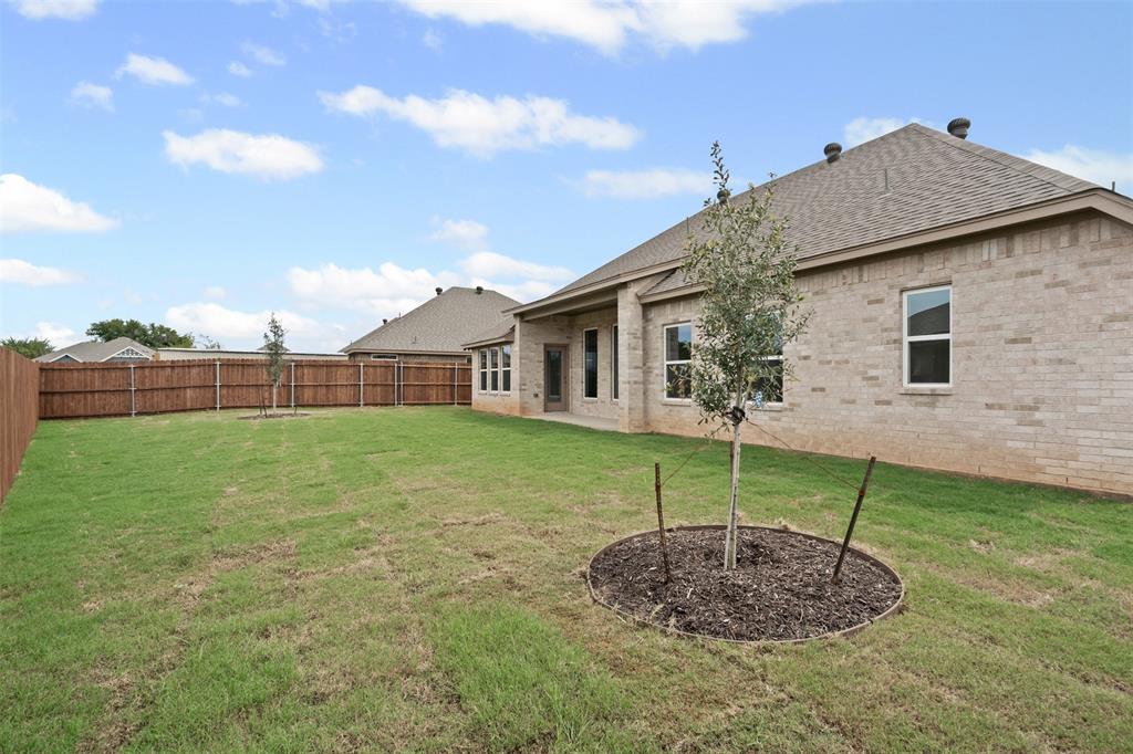 725 Jameson Springtown, TX 76082 - Photo 32 of 38 a view of a house with a backyard