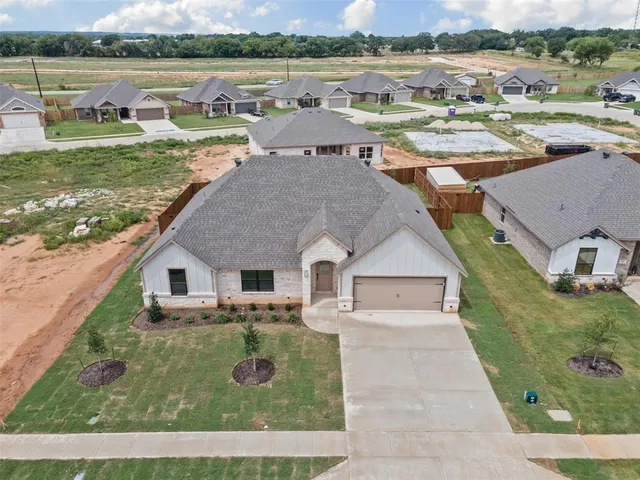 an aerial view of a house with garden and lake view