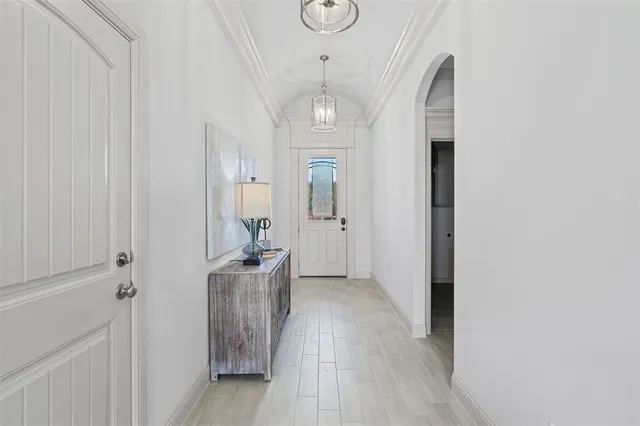 a very nice looking hallway with wooden floor