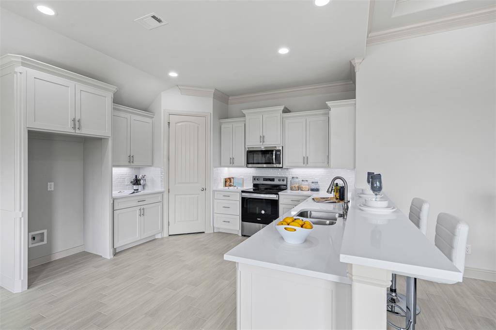 725 Jameson Springtown, TX 76082 - Photo 10 of 38 a kitchen that has a lot of cabinets in it and appliances
