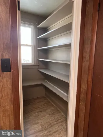 a view of walk in closet with empty racks