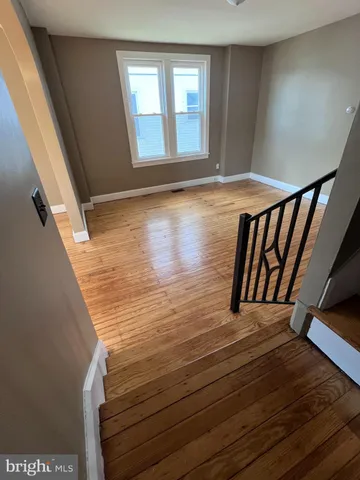 a view of wooden floor and windows in a room