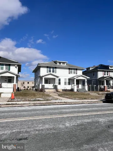 a big house next to a road