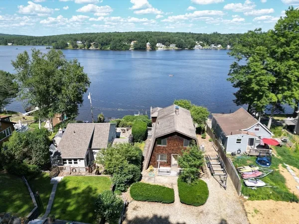 an aerial view of a house with yard swimming pool and outdoor seating