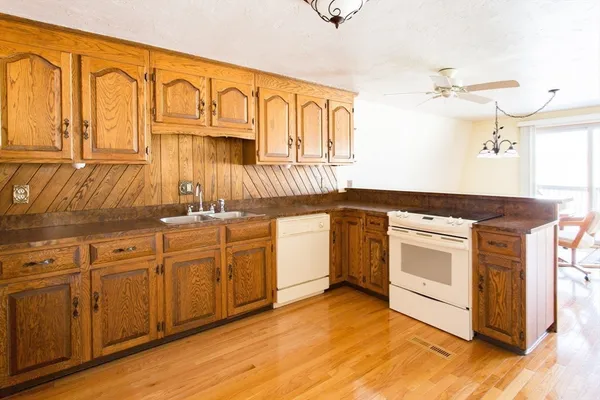 a living room with dining table and a chandelier