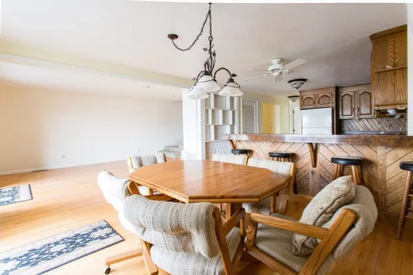a living room with furniture fireplace and a large window