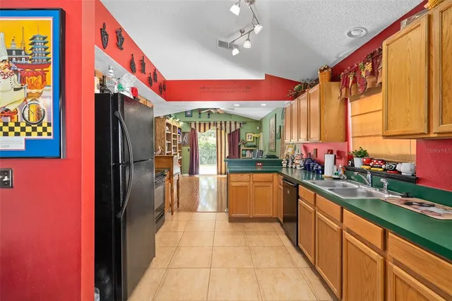 a kitchen with stainless steel appliances granite countertop a refrigerator and sink