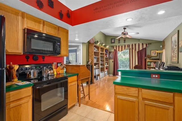 a kitchen with stainless steel appliances granite countertop a stove and cabinets