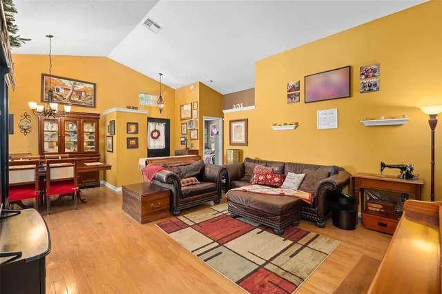 a living room with furniture a flat screen tv and a table