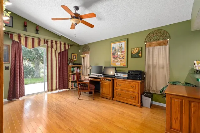 a view of a workspace with furniture and a window