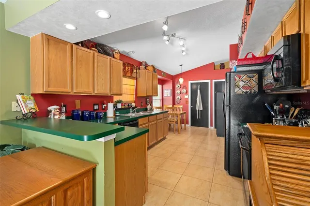 a kitchen with stainless steel appliances granite countertop a sink and cabinets