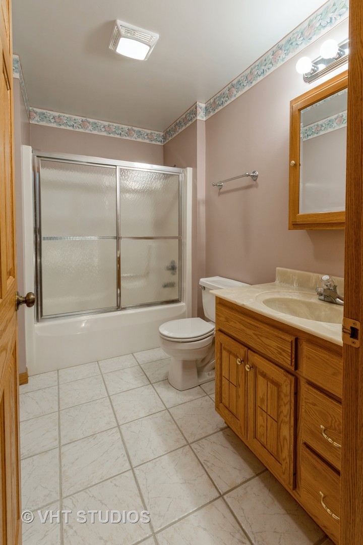 3440 Hermann Road Lee, IL 60530 - Photo 11 of 37 a bathroom with a granite countertop sink a toilet and shower