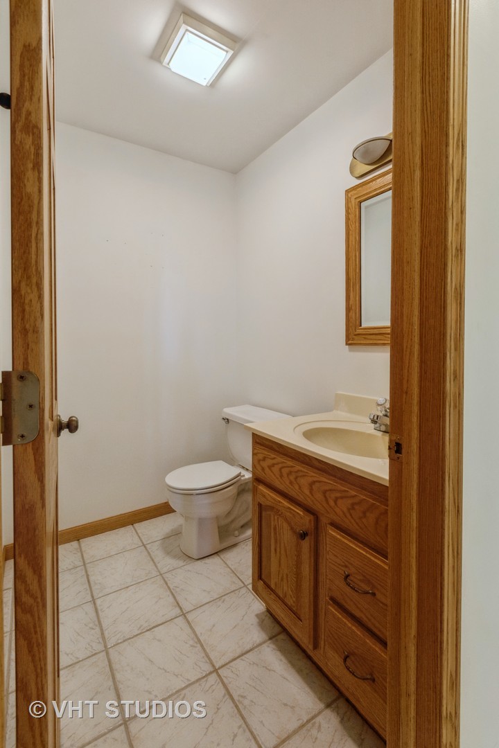 3440 Hermann Road Lee, IL 60530 - Photo 17 of 37 a bathroom with a granite countertop toilet and sink