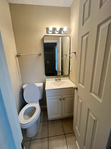 a bathroom with a sink toilet and mirror