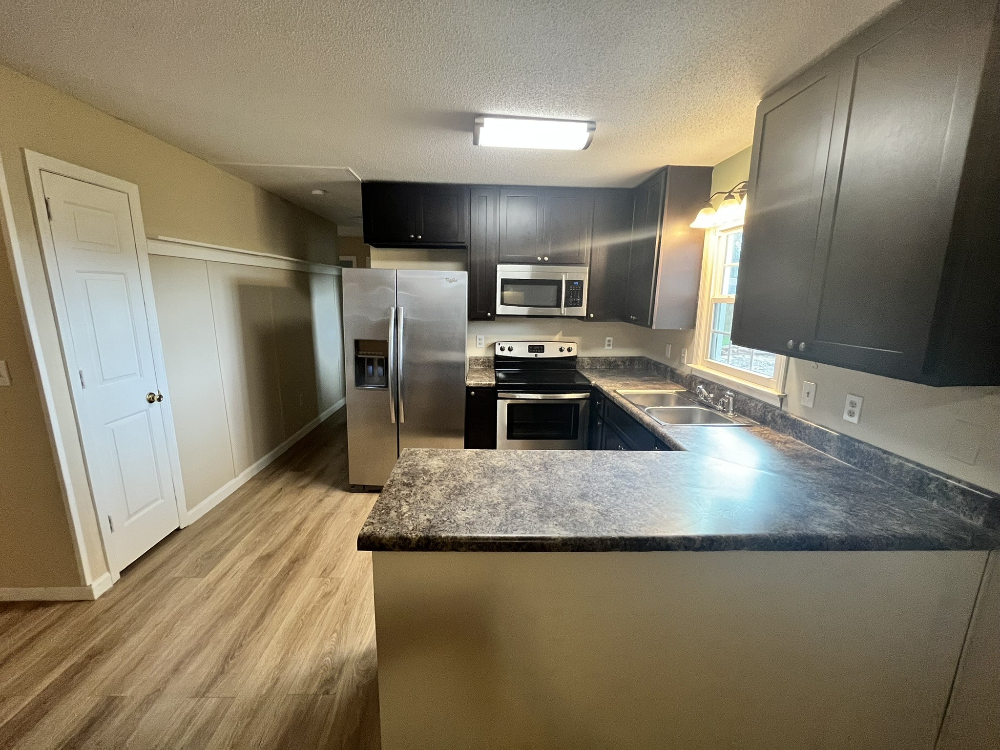 418 Woods Edge Road Winchester, TN 37398 - Photo 10 of 11 a kitchen with kitchen island a counter top space a sink and refrigerator