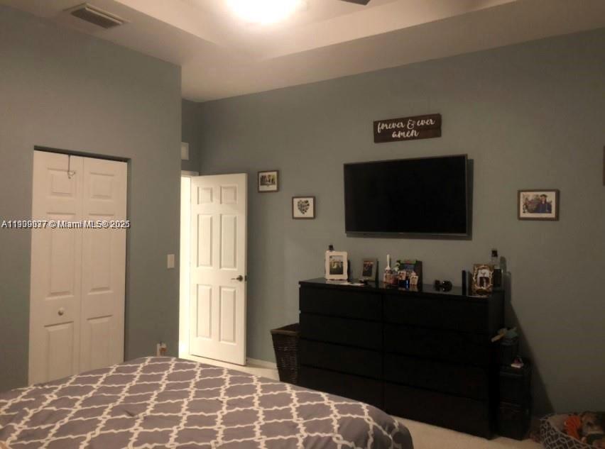 4913 Southwest 141st Avenue, Unit 2 Miramar, FL 33027 - Photo 9 of 12 a living room with furniture and a flat screen tv